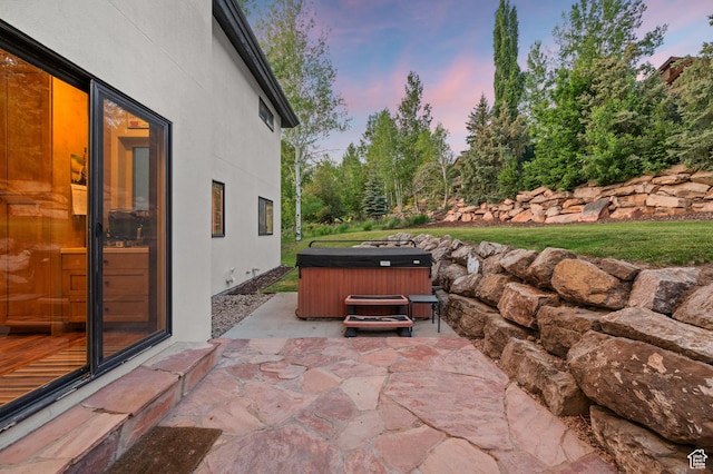8932 Flint Way, Park City, UT 84098 - patio terrace at dusk featuring a hot tub and a patio