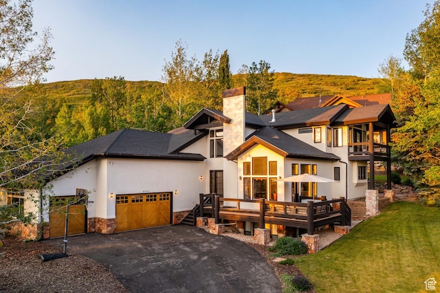 8932 Flint Way, Park City, UT 84098 - view of front of property with a chimney, an attached garage, asphalt driveway, a front lawn, and stone siding