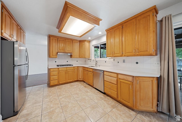1591 E Waters Ln, Sandy, UT 84093 - kitchen with appliances with stainless steel finishes, a sink, under cabinet range hood, tasteful backsplash, and light countertops