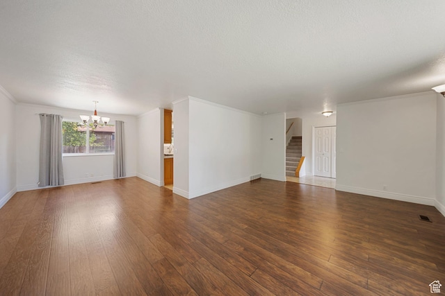 1591 E Waters Ln, Sandy, UT 84093 - unfurnished living room with a chandelier, dark wood-style flooring, stairs, baseboards, and a textured ceiling