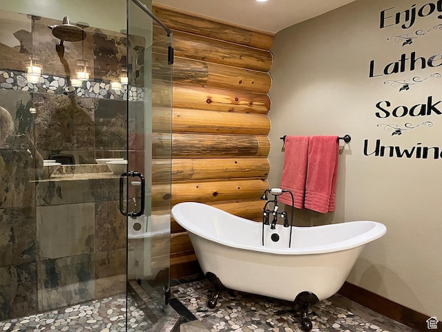 2665 Government Dam Rd, Soda Springs, ID 83276 - full bath with log walls, a shower stall, a freestanding tub, and baseboards