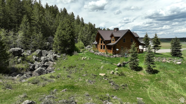 2665 Government Dam Rd, Soda Springs, ID 83276 - view of side of home featuring a chimney, log siding, and metal roof