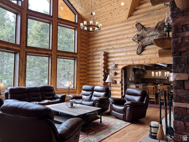 2665 Government Dam Rd, Soda Springs, ID 83276 - living area with high vaulted ceiling, hardwood / wood-style floors, a chandelier, log walls, and healthy amount of natural light