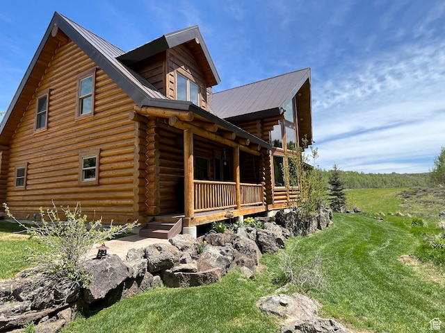 2665 Government Dam Rd, Soda Springs, ID 83276 - view of property exterior featuring log siding, a porch, and metal roof