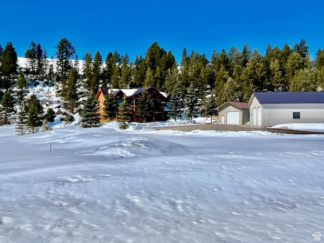 2665 Government Dam Rd, Soda Springs, ID 83276 - snowy yard featuring an outdoor structure and a garage