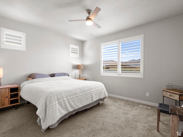 9558 S Lea Heather Way, West Jordan, UT 84081 - bedroom featuring carpet flooring, baseboards, ceiling fan, and a textured ceiling