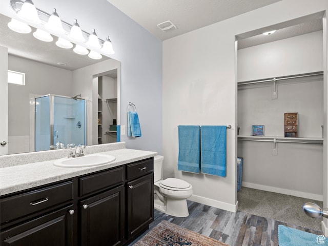9558 S Lea Heather Way, West Jordan, UT 84081 - full bath featuring a walk in closet, a shower stall, vanity, toilet, and wood finished floors