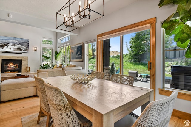 7841 Engen Loop, Park City, UT 84098 - dining area with light wood-style floors, a fireplace, and a textured ceiling