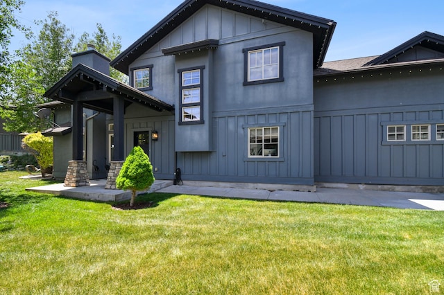 7841 Engen Loop, Park City, UT 84098 - view of front of house with board and batten siding, a front lawn, and a chimney