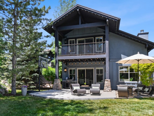 7841 Engen Loop, Park City, UT 84098 - back of property featuring a balcony, board and batten siding, a patio, and a chimney