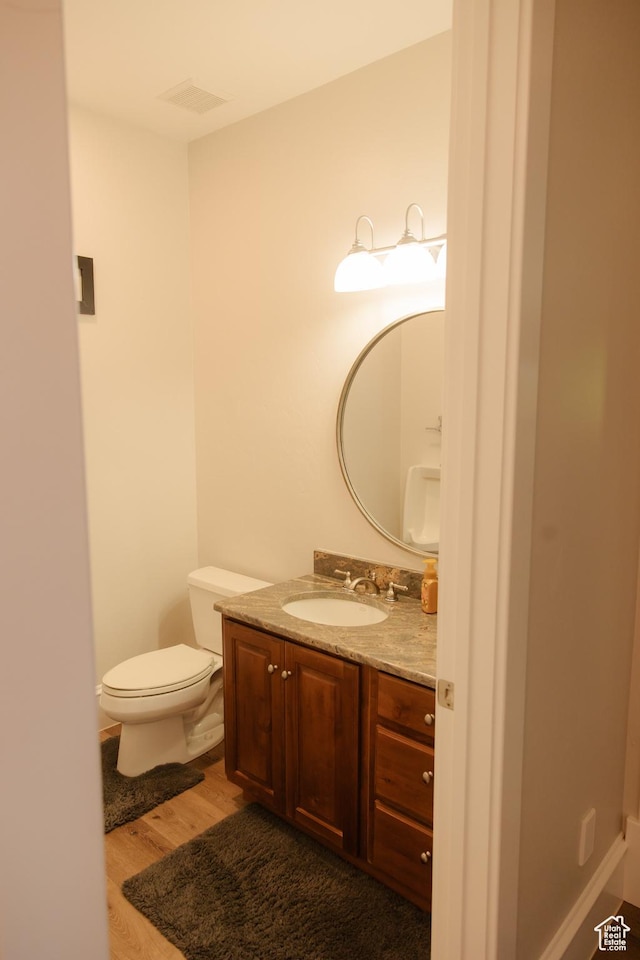 1380 N 300 W, Blanding, UT 84511 - half bath featuring wood finished floors, vanity, and toilet