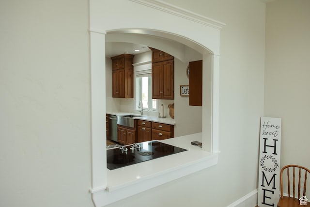 1380 N 300 W, Blanding, UT 84511 - kitchen featuring a sink, black electric cooktop, dishwasher, arched walkways, and brown cabinetry