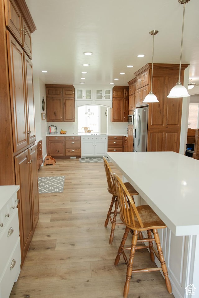 1380 N 300 W, Blanding, UT 84511 - kitchen with stainless steel appliances, brown cabinetry, light wood finished floors, and recessed lighting