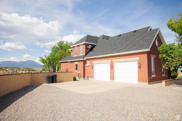1380 N 300 W, Blanding, UT 84511 - view of property exterior with driveway, roof with shingles, brick siding, and a mountain view