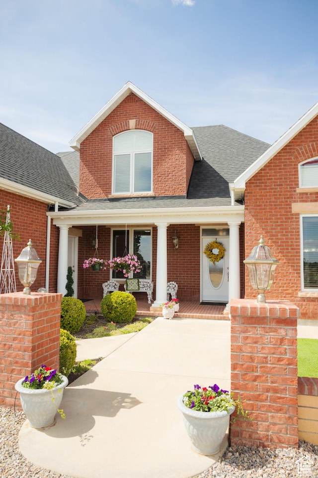 1380 N 300 W, Blanding, UT 84511 - view of front of house with a porch, brick siding, and roof with shingles