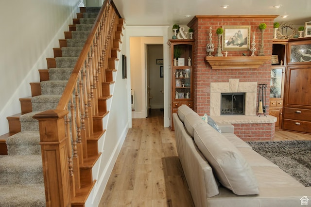 1380 N 300 W, Blanding, UT 84511 - living room with light wood-style flooring, stairs, baseboards, recessed lighting, and a fireplace