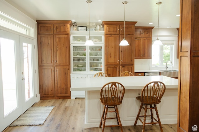 1380 N 300 W, Blanding, UT 84511 - kitchen with a sink, a breakfast bar, light countertops, brown cabinetry, and recessed lighting