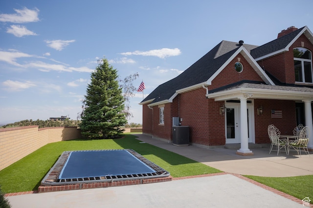 1380 N 300 W, Blanding, UT 84511 - view of side of home featuring brick siding, a patio area, central AC unit, and roof with shingles