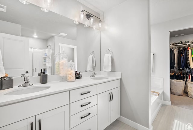 4185 W 800 S, Syracuse, UT 84075 - full bathroom with a shower stall, double vanity, a spacious closet, baseboards, and tile patterned floors