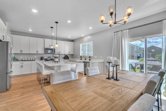 4185 W 800 S, Syracuse, UT 84075 - dining space featuring a chandelier, light wood-style flooring, and recessed lighting