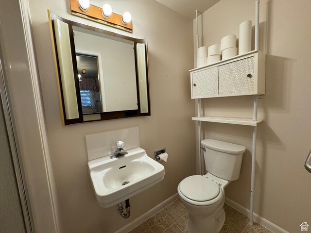 2650 S 2000 W, Syracuse, UT 84075 - bathroom with a sink, toilet, baseboards, and tile patterned floors