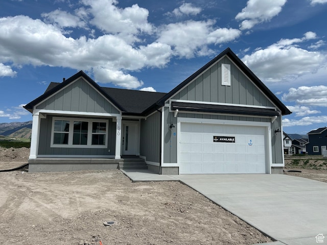 570 N 600 W, Smithfield, UT 84335 - view of front facade featuring driveway, a garage, covered porch, and board and batten siding