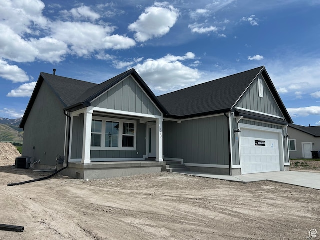 570 N 600 W, Smithfield, UT 84335 - modern farmhouse featuring driveway, a garage, central air condition unit, covered porch, and roof with shingles