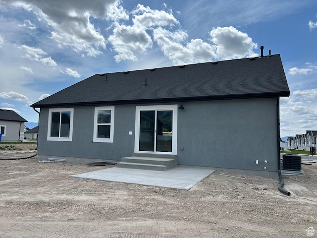 570 N 600 W, Smithfield, UT 84335 - rear view of property with stucco siding, roof with shingles, a patio area, and central AC unit