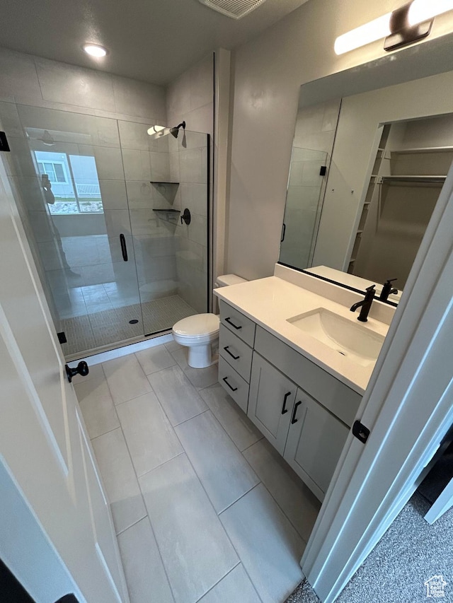 570 N 600 W, Smithfield, UT 84335 - bathroom featuring vanity, a stall shower, a walk in closet, and toilet