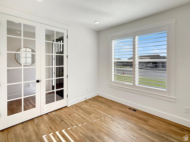 2558 N 1150 E, North Ogden, UT 84414 - empty room with baseboards, healthy amount of natural light, wood finished floors, and a textured ceiling