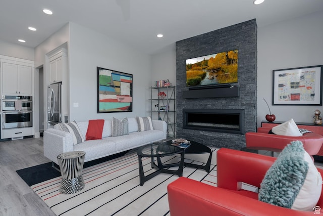 11579 N Groves Edge Dr, Hideout, UT 84036 - living area featuring light wood-style flooring, recessed lighting, and a stone fireplace