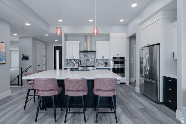 11579 N Groves Edge Dr, Hideout, UT 84036 - kitchen with appliances with stainless steel finishes, wall chimney range hood, baseboards, light wood-style flooring, and recessed lighting