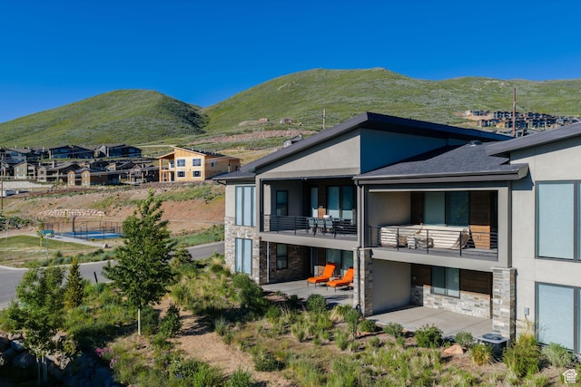 11579 N Groves Edge Dr, Hideout, UT 84036 - back of property with stone siding, stucco siding, and a balcony