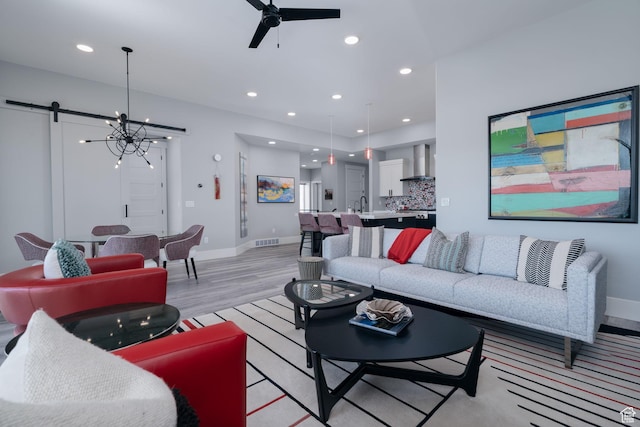 11579 N Groves Edge Dr, Hideout, UT 84036 - living room featuring light wood-type flooring, baseboards, a ceiling fan, recessed lighting, and a chandelier