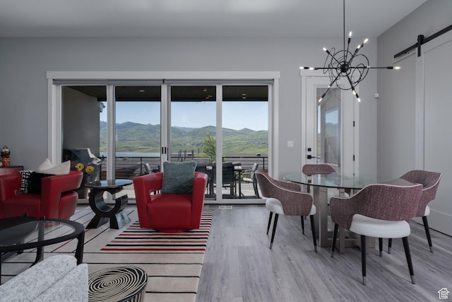 11579 N Groves Edge Dr, Hideout, UT 84036 - living area featuring wood finished floors, a barn door, a mountain view, and healthy amount of natural light