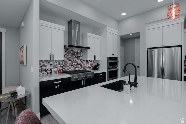 11579 N Groves Edge Dr, Hideout, UT 84036 - kitchen with stainless steel appliances, wall chimney exhaust hood, a sink, light countertops, and recessed lighting
