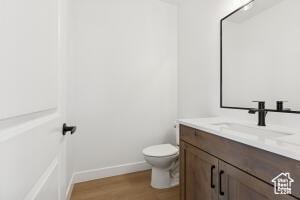 579 S 1800 W, Hurricane, UT 84737 - half bath with vanity, toilet, wood finished floors, and baseboards