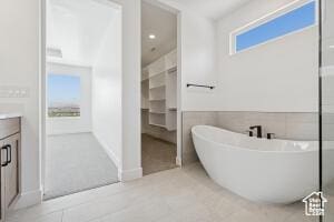 579 S 1800 W, Hurricane, UT 84737 - bathroom with a freestanding bath, vanity, a walk in closet, and tile patterned floors