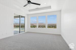 579 S 1800 W, Hurricane, UT 84737 - carpeted empty room with a raised ceiling, a ceiling fan, and baseboards