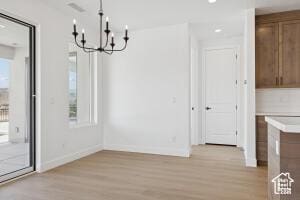 579 S 1800 W, Hurricane, UT 84737 - unfurnished dining area featuring light wood-style flooring, a chandelier, baseboards, and plenty of natural light