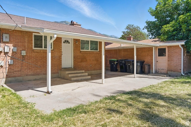 3025 N 250 E, Provo, UT 84604 - rear view of property featuring a chimney, brick siding, and a patio