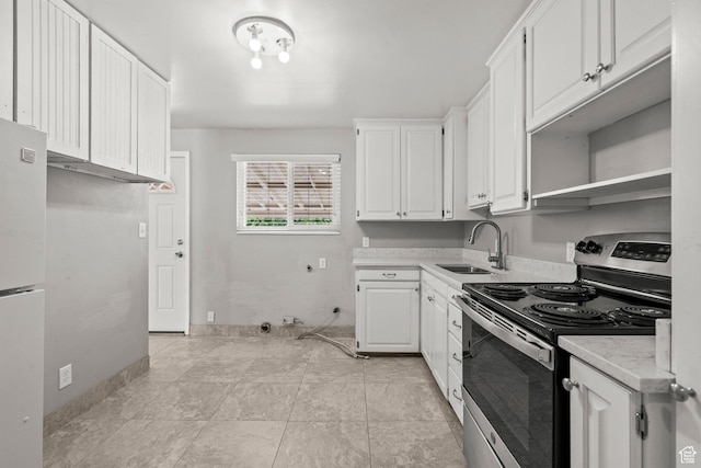 3025 N 250 E, Provo, UT 84604 - kitchen featuring electric stove, a sink, light countertops, freestanding refrigerator, and white cabinetry
