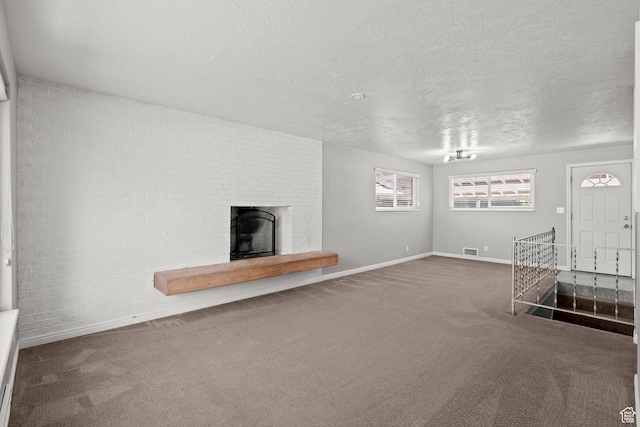 3025 N 250 E, Provo, UT 84604 - unfurnished living room featuring carpet floors, a fireplace, baseboards, and a textured ceiling