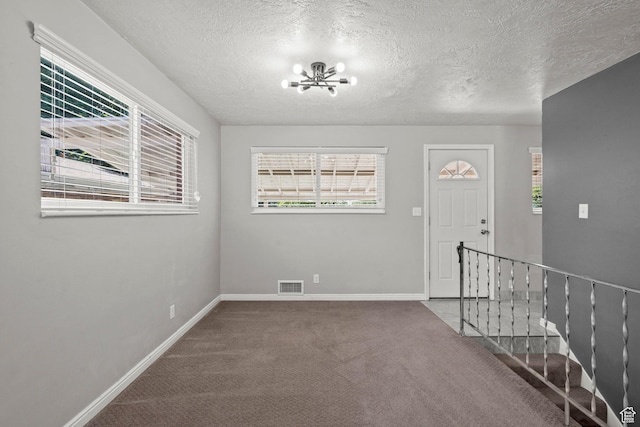 3025 N 250 E, Provo, UT 84604 - entrance foyer featuring carpet floors, baseboards, a chandelier, plenty of natural light, and a textured ceiling