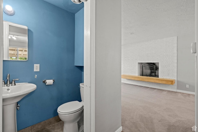 3025 N 250 E, Provo, UT 84604 - half bath featuring toilet, baseboards, a sink, and a brick fireplace