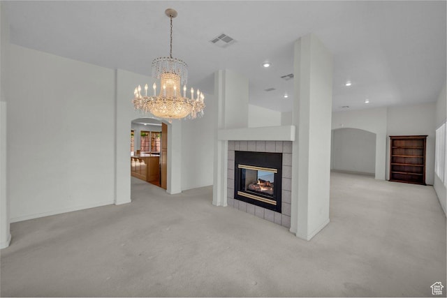 3350 S Fairway Rd, St George, UT 84790 - unfurnished living room with arched walkways, carpet flooring, a chandelier, a tile fireplace, and recessed lighting
