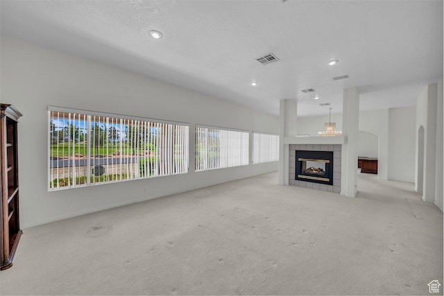 3350 S Fairway Rd, St George, UT 84790 - unfurnished living room with carpet, a tile fireplace, a chandelier, and recessed lighting