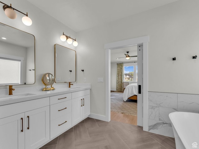 569 W Cascade Loop, Midway, UT 84049 - bathroom featuring double vanity, a freestanding tub, ceiling fan, ensuite bathroom, and tile walls