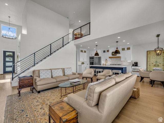 569 W Cascade Loop, Midway, UT 84049 - living room featuring a high ceiling, a chandelier, light wood finished floors, recessed lighting, and stairs