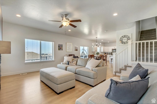 753 N Stallion Dr Unit 601, Spanish Fork, UT 84660 - living area with stairway, a ceiling fan, a chandelier, recessed lighting, and light wood-style floors